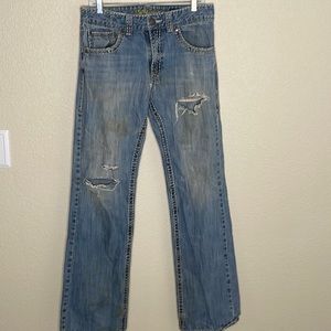 Very distressed Wrangler jeans.